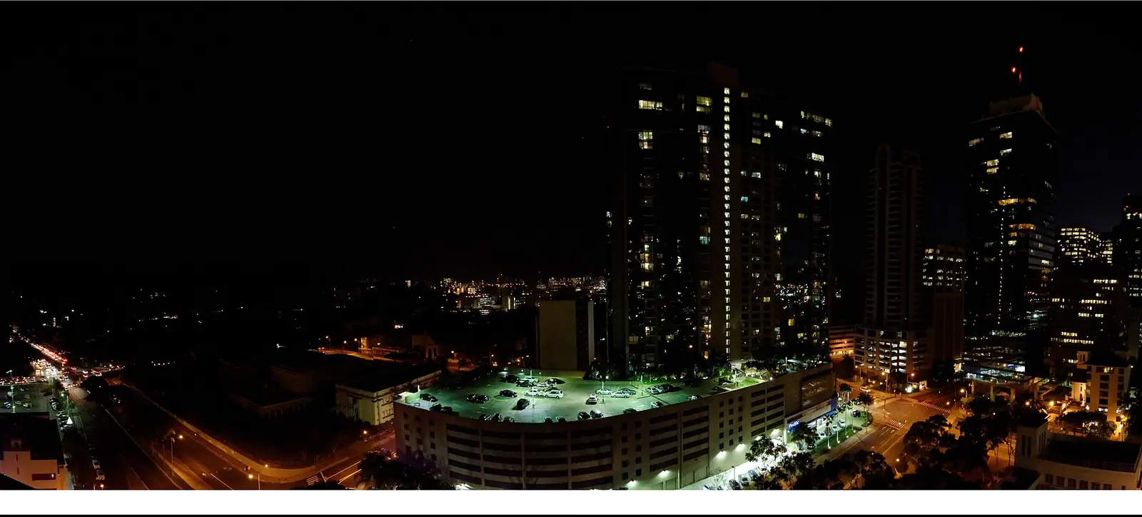 Honolulu at dusk on 12 January 2015 during a rolling power outage, with most of the neighbourhood dark and a few distant lights still on.